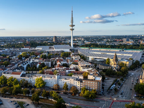 Aerial view of the Hamburg Messe exhibition center with the Heinrich-Hertz-Turm in the background, surrounded by urban buildings and greenery in Hamburg, Hamburg, Germany.