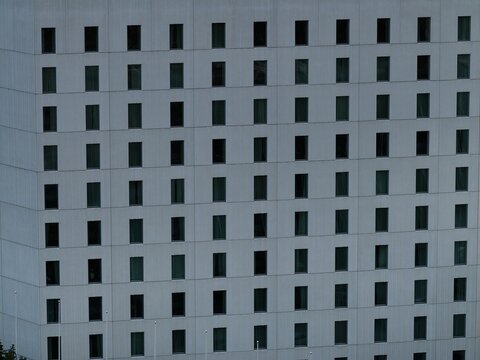 Aerial view of the grid-like facade of a modern building featuring numerous uniform windows in Tampere, Pirkanmaa, Finland.