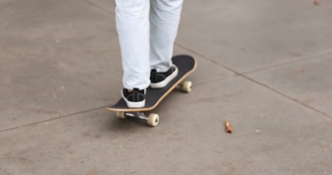 Man riding skateboard on city street, closeup