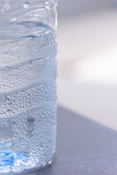 Close up of chilled plastic water bottle covered condensation droplets showing freshness hydration cooling clean drinking water copy space
