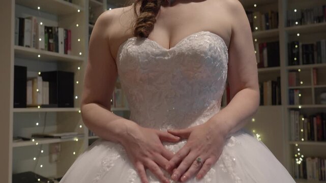 Upward tilt reveals a brides elegant wedding dress indoors in Brittany France