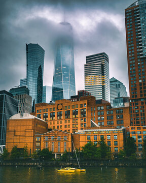 Foggy New York City Skyline with One World Trade Center and Dramatic Clouds