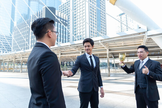 Happy asian business people team winners laughing give high five together join hands celebrating connection spirit good relation, successful teamwork victory, unity and teambuilding.teamwork