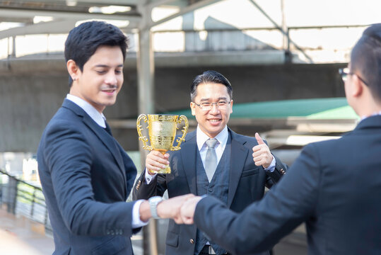 Happy asian business people team winners laughing give high five together join hands celebrating connection spirit good relation, successful teamwork victory, unity and teambuilding.teamwork