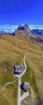 The Sofie hut, behind it the peaks Sas Rigais and Furchetta of the Geisler group, panoramic photo, drone photo, Val Gardena, Dolomites, Autonomous Province of Bolzano, South Tyrol, ItalyDefault