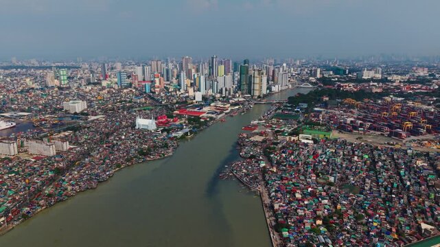 High drone view reveals crowded districts beside Pasig River and Manila Bay