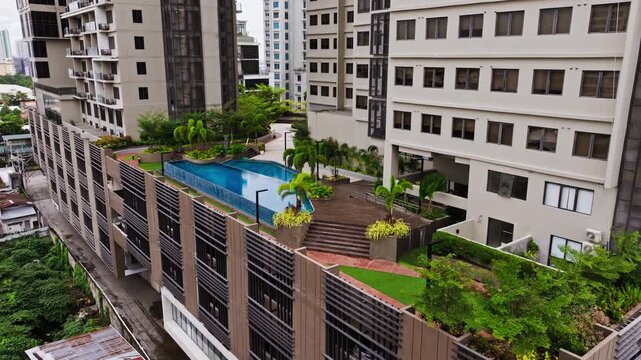 Blue infinity pool and lush palms crown a modern condominium in Cebu City