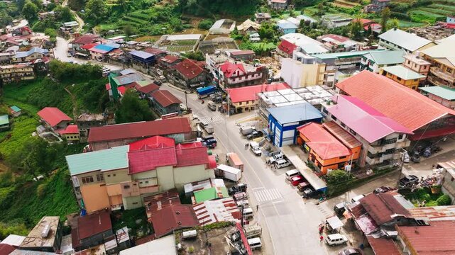 Drone orbit reveals colorful buildings and mountain roads in Atok, Benguet