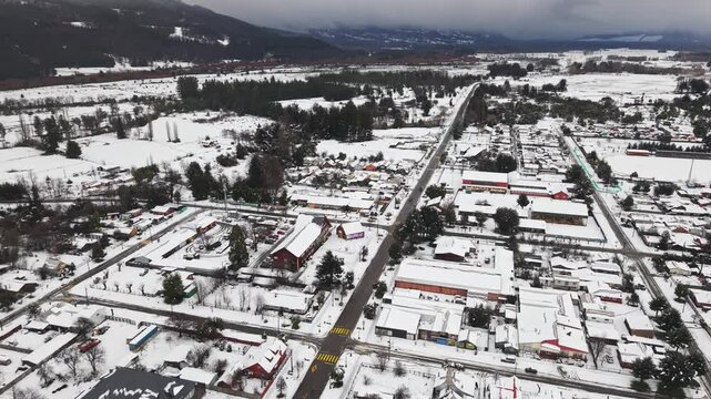 Aerial Above Melipeuco Town Streets Traffic Snow Covered Roofs Mountains Chile Urban City Landscape