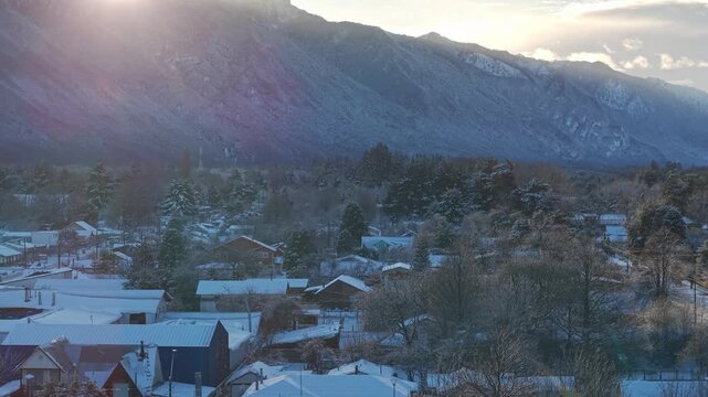 Aerial Drone Flight Melipeuco Rooftops Sunrise Snow Mountains Chile Town Tilt up
