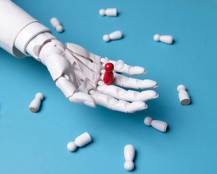 Robotic Hand Picking Red Wooden Pawn Figure Concept of AI Recruitment and Leadership
