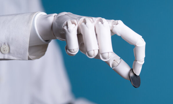 Robotic Hand Holding Blank Metal Coin Isolated on Blue Background