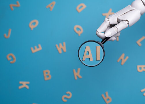 Robotic Hand Holding Magnifying Glass over AI Letters Concept