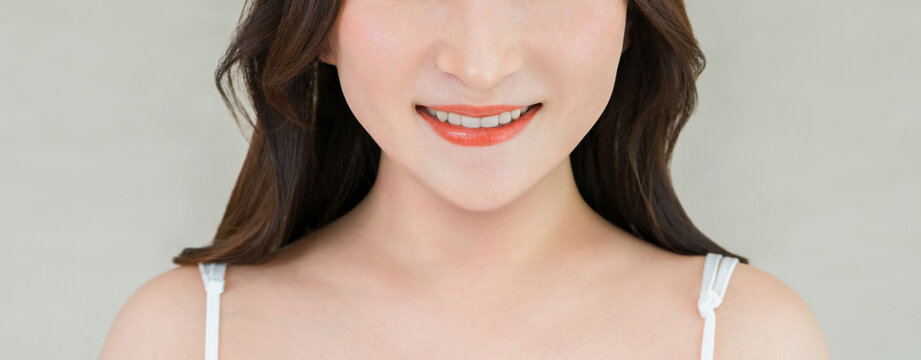A woman's smile showing her white teeth; dental care, teeth whitening, orthodontics.