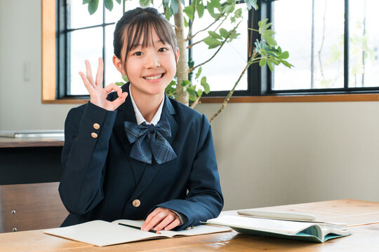 Elementary, middle, and high school girls in their school uniforms studying at home