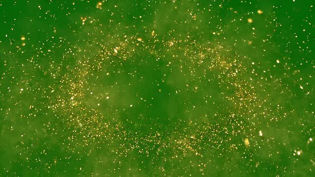Golden particles exploding and scattering across a vibrant green screen background, perfect for adding festive celebration magic to holiday events and abstract design projects.