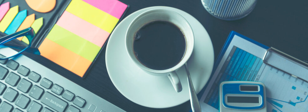 Banner Excel graph with Spreadsheet Document showing Information Financial Startup Concept. Banner Office laptop business financial document chart and graph on office wooden table coffee cup.
