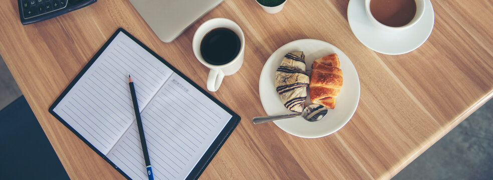 Banner Excel graph with Spreadsheet Document showing Information Financial Startup Concept. Banner Office laptop business financial document chart and graph on office wooden table coffee cup.