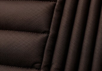Obraz premium Close up view of dark brown quilted fabric texture with horizontal and vertical stitching lines.