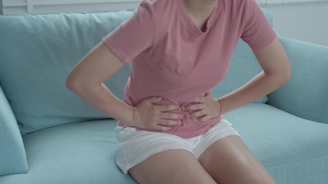stomach ache. Asian women have abdominal pain, indigestion, gastritis, menstrual cramps, flatulence, diarrhea, distention, colon cancer, belly inflammation problem, suffer food poisoning, abdomen