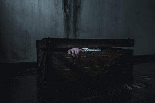 ghost horror creepy scary have hair covering face and eye lying in the old treasure chest