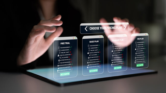 Hands Interacting with a Digital Display of Various Pricing Plans for a Subscription Service in a High-Tech Environment Quark.