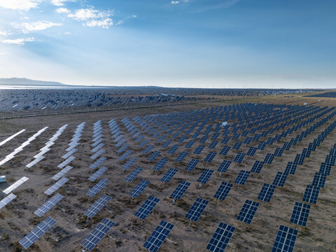 Aerial view of large scale solar panel array in desert landscape