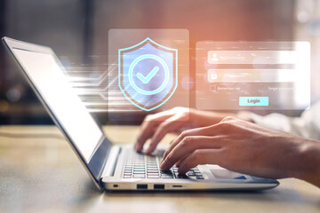 Obraz premium A close-up shot of hands typing on a laptop keyboard emphasizing digital security with a login screen and a protective shield icon representing online safety. Gantry