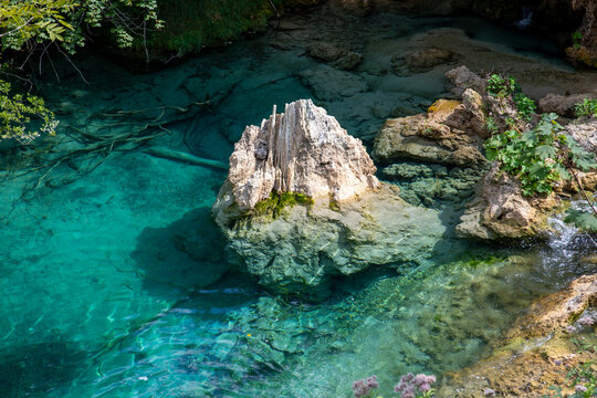 View of the turquoise waters and limestone rock formations at Plitvice Lakes National Park, Croatia.