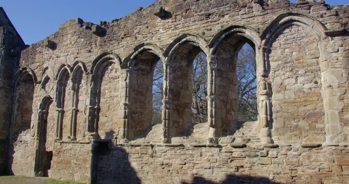 shot of stone mullion windows at Basingwerk Abbey