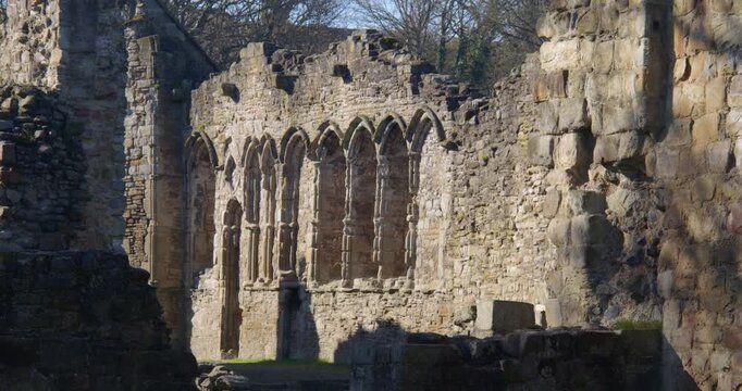 Wide zoom in shot of stone mullion windows at Basingwerk Abbey