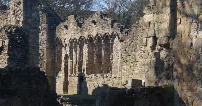 Wide shot of stone mullion windows at Basingwerk Abbey