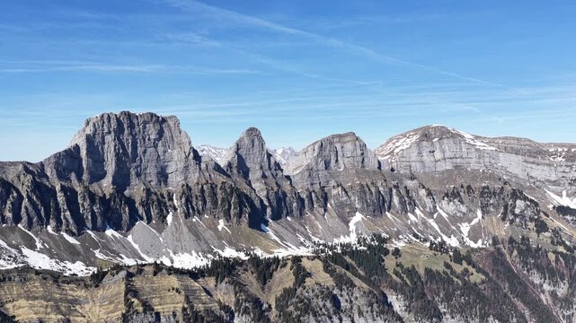 Elevated aerial perspective of the Churfirsten above Walensee, capturing the imposing limestone formations, snow-dusted slopes and layered alpine ridges around Walenstadt.