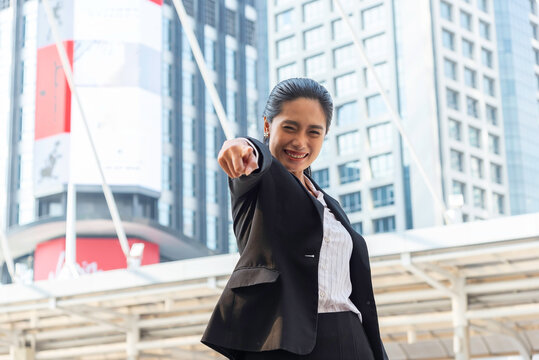Business woman in suit look to future on building background in city outdoor and celebrating for success work at the office, investment concept, success concept
