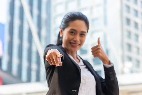 Business woman in suit look to future on building background in city outdoor and celebrating for success work at the office, investment concept, success concept