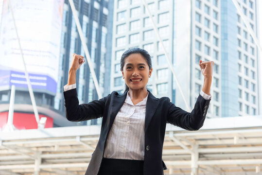 Business woman in suit look to future on building background in city outdoor and celebrating for success work at the office, investment concept, success concept