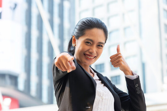 Business woman in suit look to future on building background in city outdoor and celebrating for success work at the office, investment concept, success concept