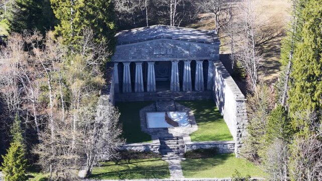 Paxmal Switzerland aerial view ancient Greek style temple monument surrounded by forest, stone columns and pool, Walenstadt mountainside historic landmark