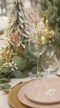 Close-up of an elegant festive table with warm decorations and Christmas lighting. 4k.