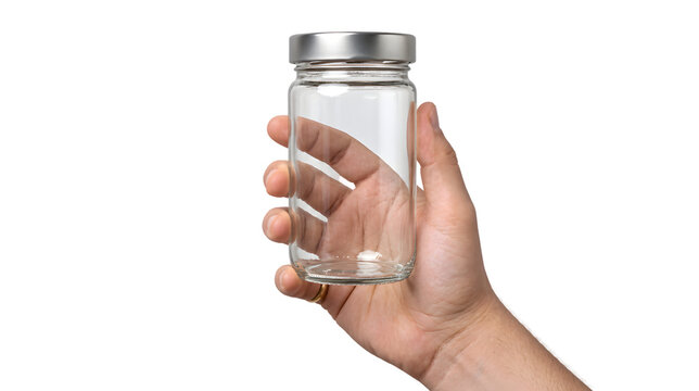 Hand holding empty transparent glass jar with metal lid