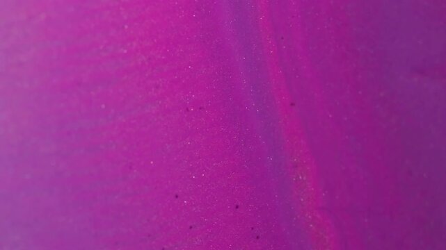 Paint stream. Glitter background. Defocused pink neon color liquid shiny texture droplets floating on creative abstraction.