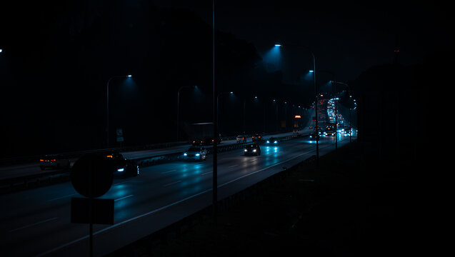 Nighttime Highway Traffic with Blue LED Headlights &mdash; Cars Driving on Dark Wet Road