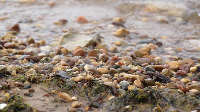 Gentle waves washing over the pebble shore of Lake Huron Michigan peaceful summer lake waves