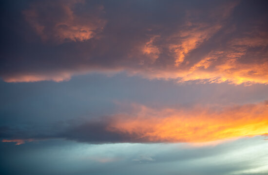 Dramatic orange and slate blue cloudscape at dawn