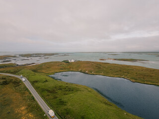 Aerial view of the coastal landscape of South Uist in the Outer Hebrides, with a road, scattered lochs and small rural settlements across the island terrain - South Uist, United Kingdom - 3 aug 2026 © IBRESTER