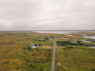 Aerial view of the coastal landscape of South Uist in the Outer Hebrides, with a road, scattered lochs and small rural settlements across the island terrain - South Uist, United Kingdom - 3 aug 2026 © IBRESTER