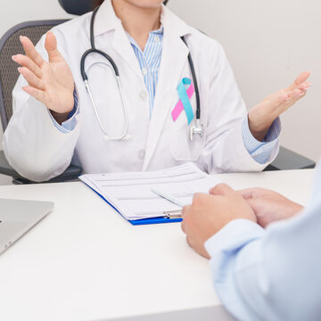 Doctor and patient having a medical consultation for blue and pink ribbon concept of October male Breast Cancer Awareness month, National Cancer Survivors Month and Pink October Healthcare
