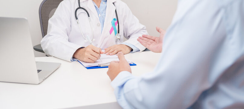 Doctor and patient having a medical consultation for blue and pink ribbon concept of October male Breast Cancer Awareness month, National Cancer Survivors Month and Pink October Healthcare