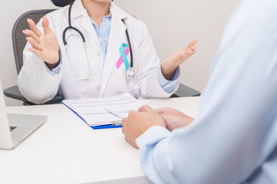 Doctor and patient having a medical consultation for blue and pink ribbon concept of October male Breast Cancer Awareness month, National Cancer Survivors Month and Pink October Healthcare