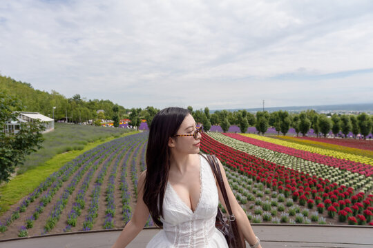 ​Woman with colorful flower fields background.